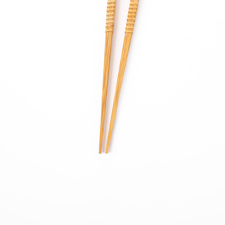 A pair of Japanese bamboo serving chopsticks featuring fine tapered tips on both ends and a textured wrapped center grip