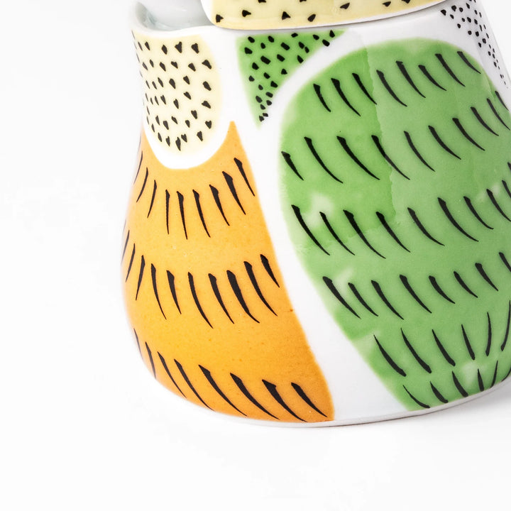 Bird-shaped soy sauce dispenser with green and yellow hand-painted details, adding a playful touch to your table.