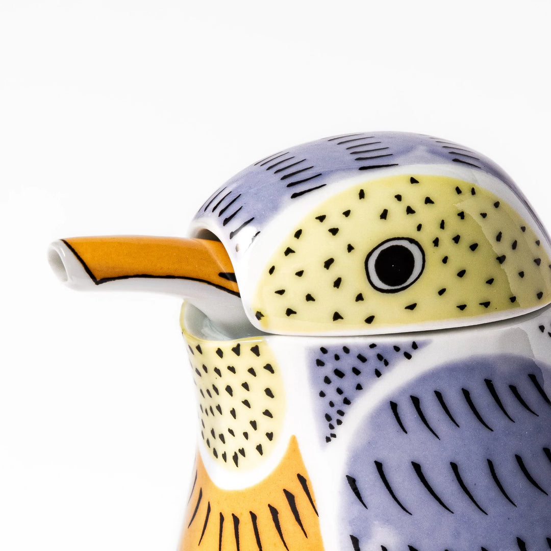 Bird-shaped soy sauce dispenser with purple and yellow hand-painted details, adding a playful touch to your table.