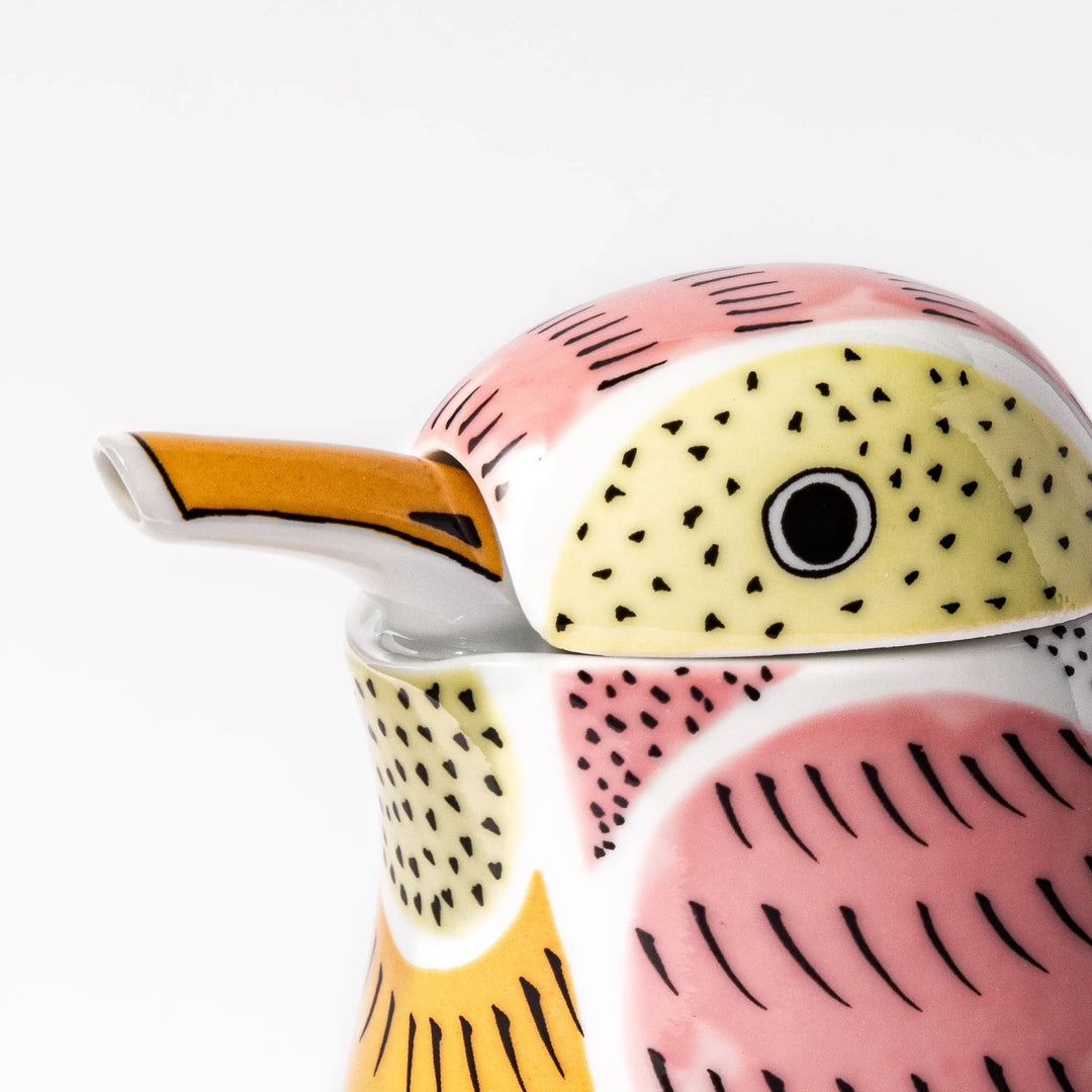 Bird-shaped soy sauce dispenser with pink and yellow hand-painted details, adding a playful touch to your table.