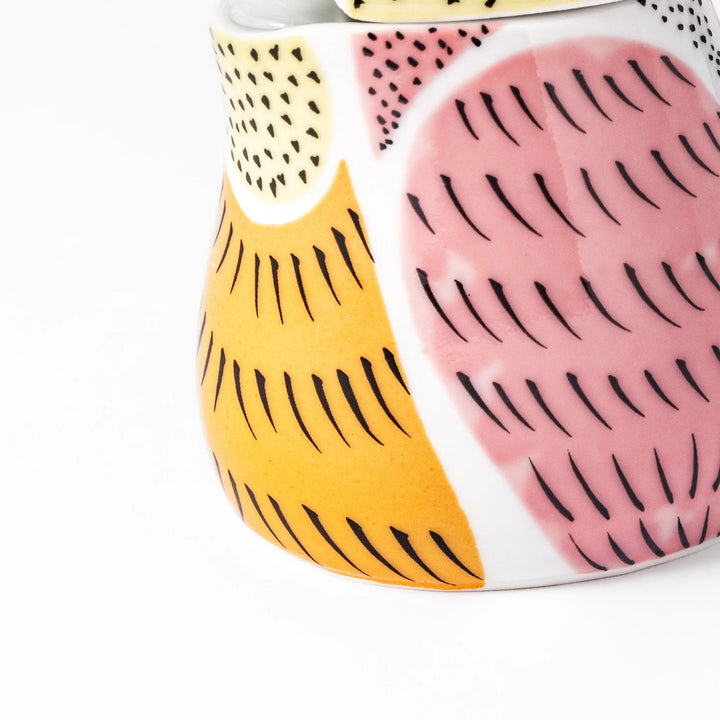 Bird-shaped soy sauce dispenser with pink and yellow hand-painted details, adding a playful touch to your table.