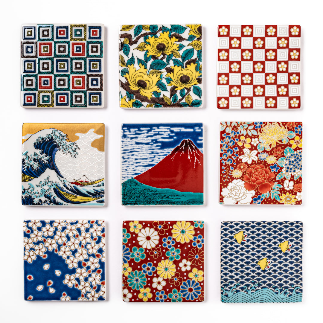 Set of Japanese ceramic coasters featuring traditional patterns like waves, Mt. Fuji, cherry blossoms, and floral motifs, perfect for elegant table settings.