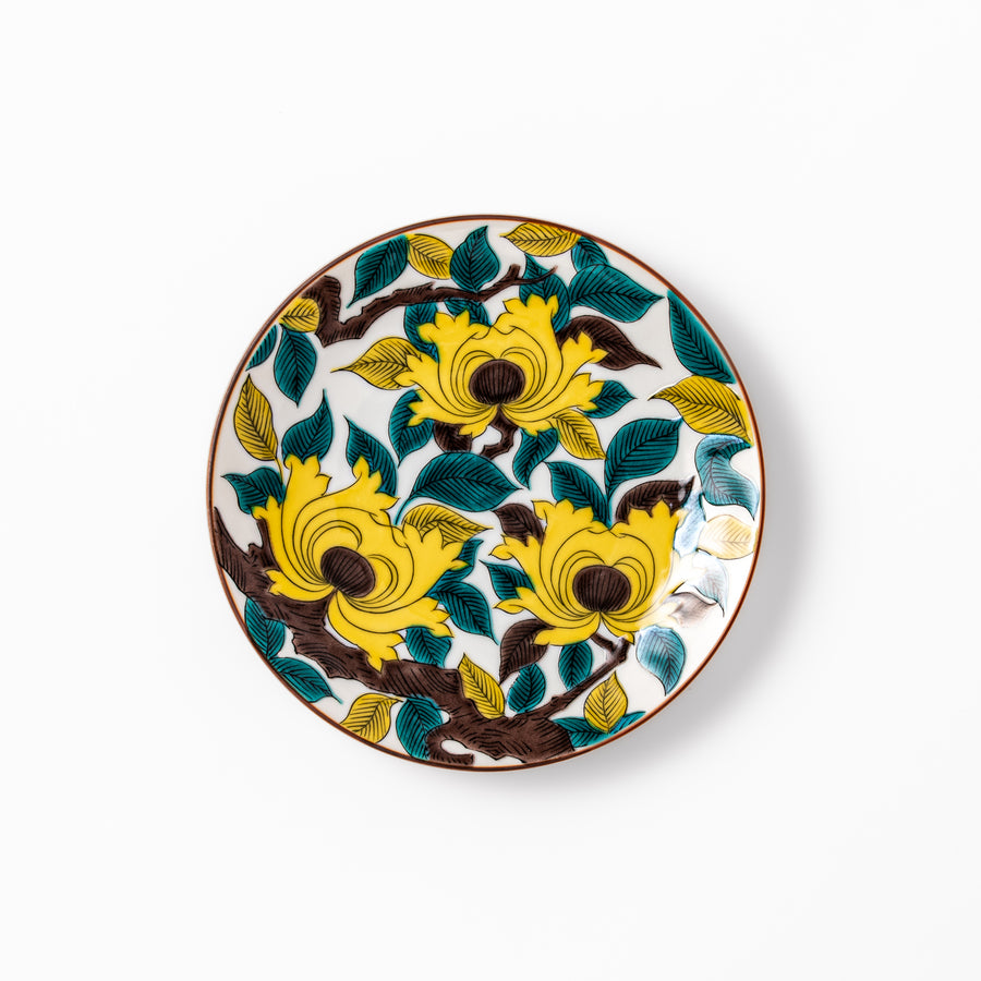 Japanese porcelain dessert plate with bold yellow peony blooms, green leaves, and brown branches on a white background
