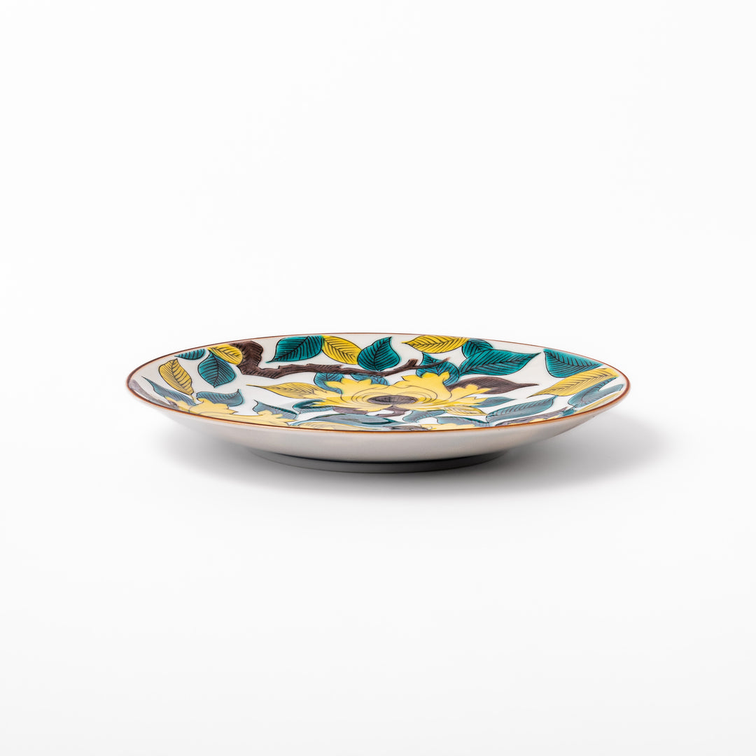 Japanese porcelain dessert plate with bold yellow peony blooms, green leaves, and brown branches on a white background