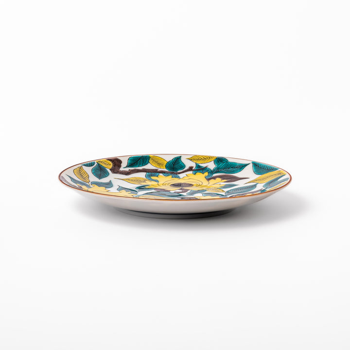Japanese porcelain dessert plate with bold yellow peony blooms, green leaves, and brown branches on a white background