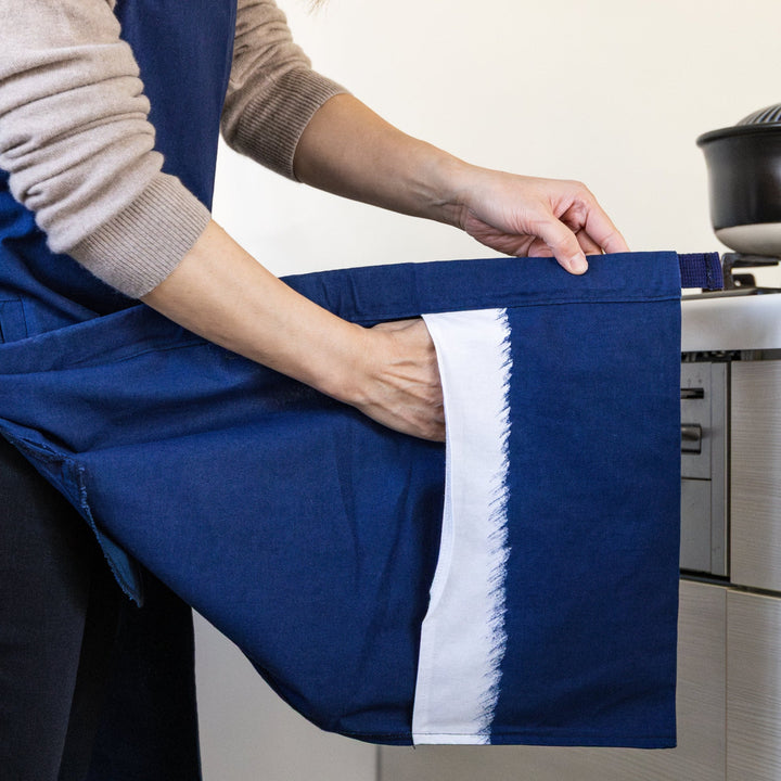 Nami from Just One Cookbook wearing navy front split apron with built in mitten pocket in kitchen