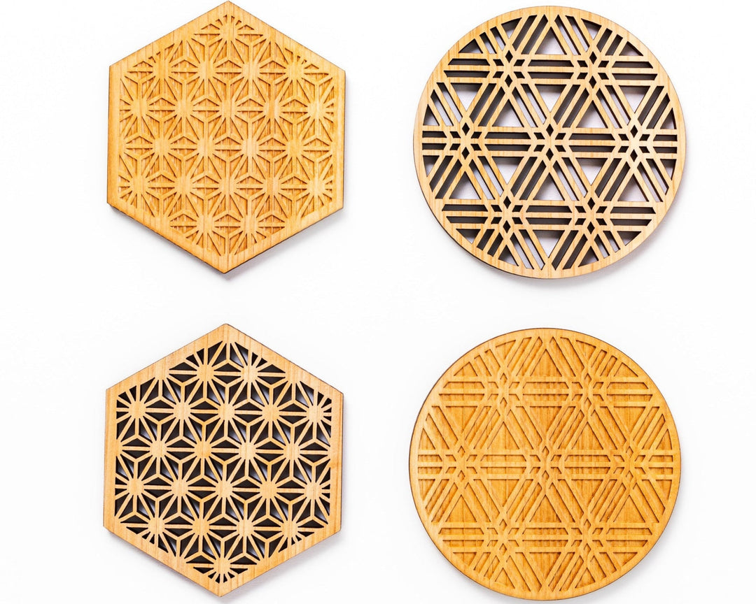 Japanese wooden coasters with detailed kumiko patterns in hexagon and round shapes displayed on a white background