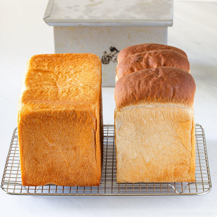 Japanese loaf pan for shokupan milk bread showing evenly baked square loaves with soft fluffy texture