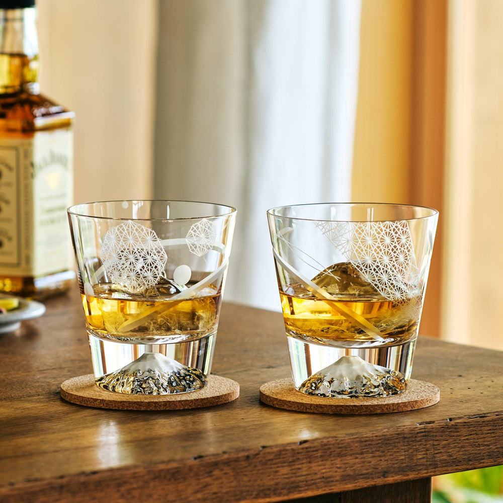 Two kiriko Japanese whiskey glasses with Mt. Fuji bases, etched with traditional geometric patterns.