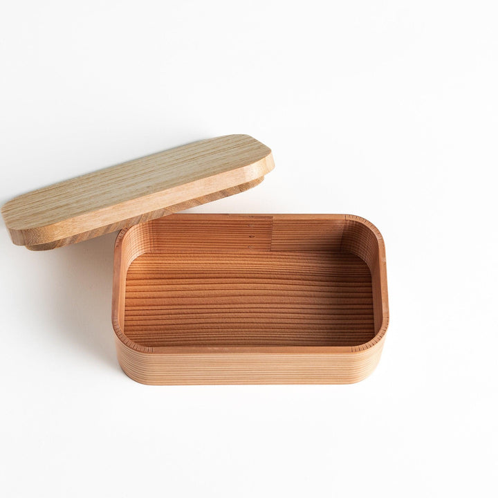 Artisan Cedar Bento Box with lid on, showcasing the natural cedar wood grain and rounded edges for a minimalist and elegant look.