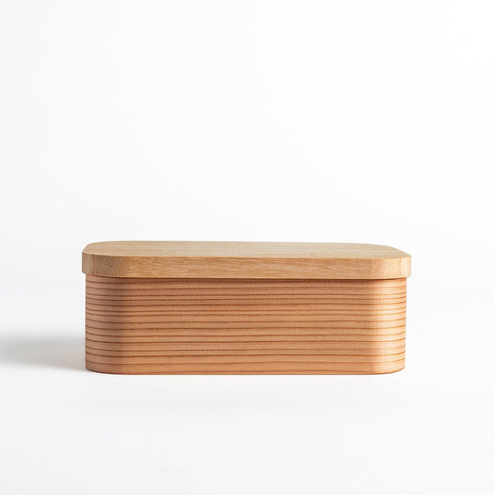 Artisan Cedar Bento Box with its lid removed, revealing the well-crafted interior and fine wooden texture.