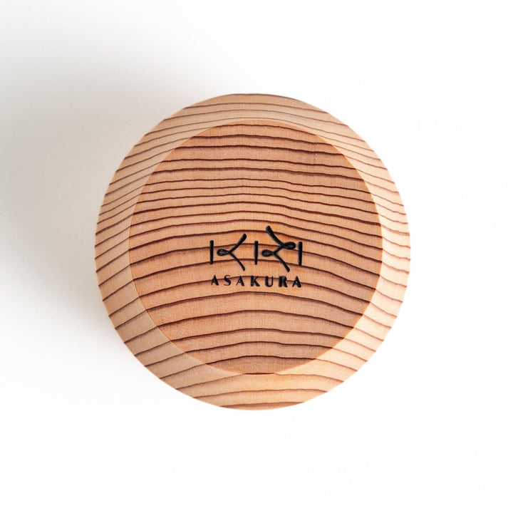 Set of Artisan Cedar Sake Cups with a natural wood grain design, perfect for serving traditional sake.