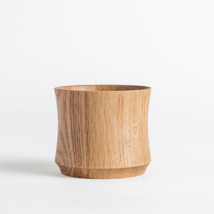 Elegant pair of whisky cups crafted from Mizunara oak, showcasing smooth curves and beautiful grain patterns. Perfect for spirits.