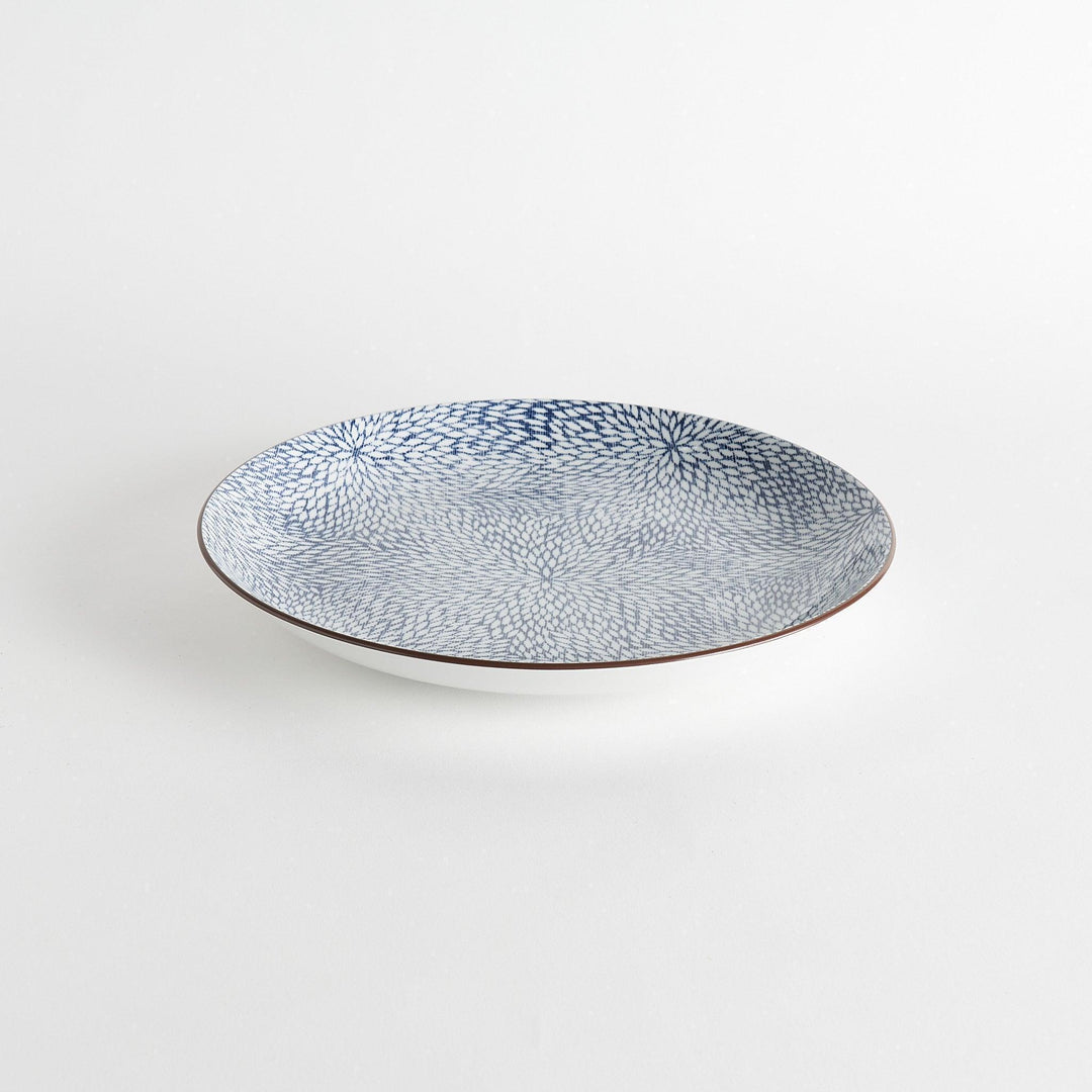 A round serving plate adorned with a detailed pattern of concentric blue dots creating a mesmerizing effect.