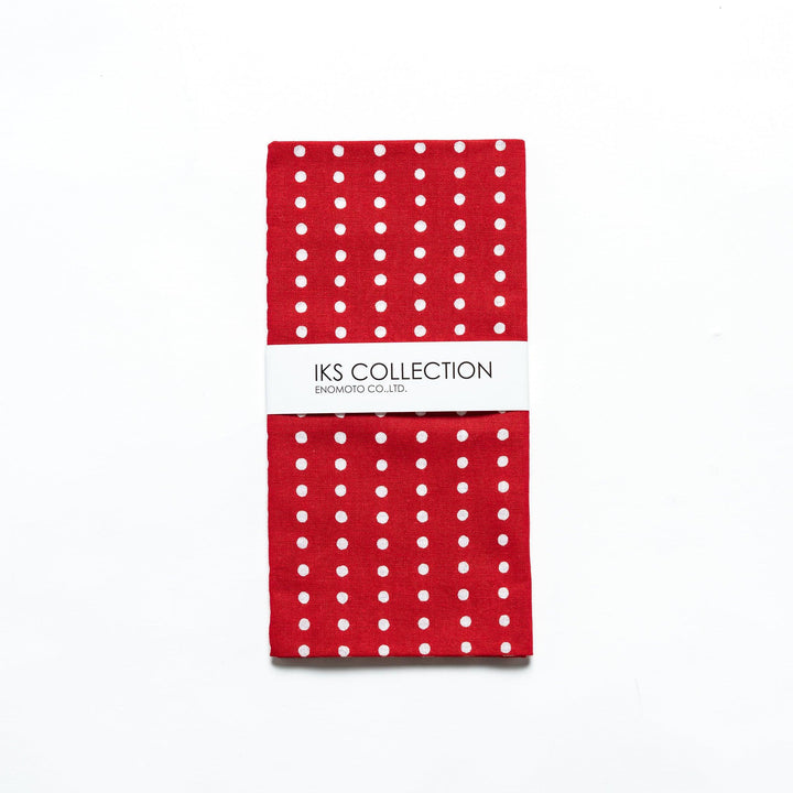 Red tenugui folded neatly, with a product sleeve for display.