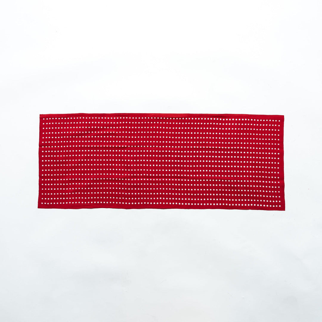 Red tenugui fully laid out, featuring white bean dot patterns in rows.