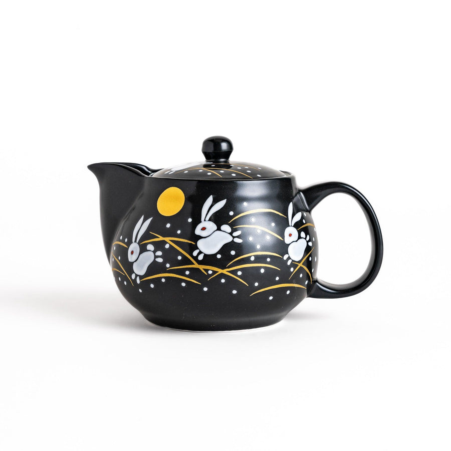 Black teapot featuring white rabbits, golden grasses, and a full moon design, inspired by traditional Japanese autumn motifs.