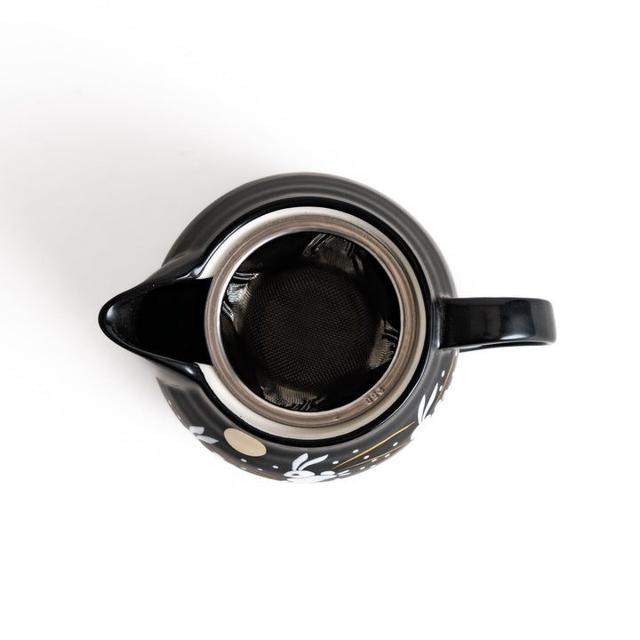 Black teapot featuring white rabbits, golden grasses, and a full moon design, inspired by traditional Japanese autumn motifs.