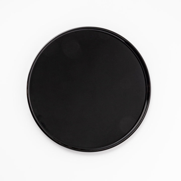 Glossy black Japanese round wooden tray with raised rim, ideal for serving tea or displaying tableware with a refined and minimalist aesthetic.