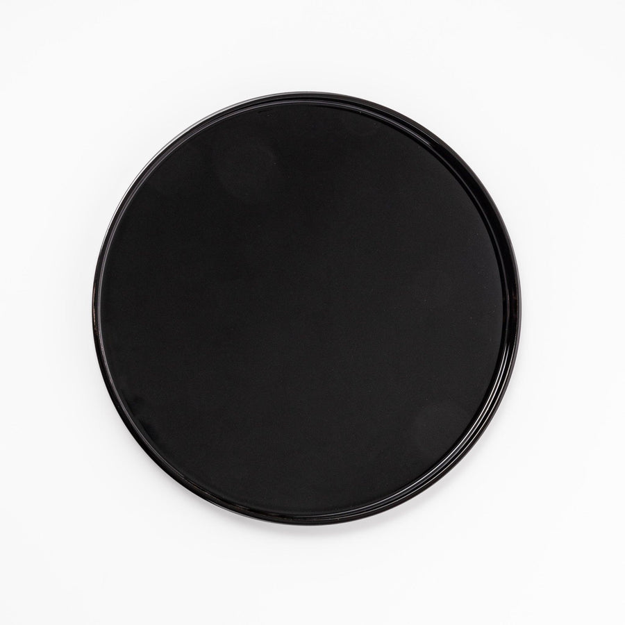 Glossy black Japanese round wooden tray with raised rim, ideal for serving tea or displaying tableware with a refined and minimalist aesthetic.