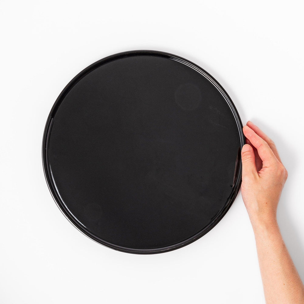 Glossy black Japanese round wooden tray with raised rim, ideal for serving tea or displaying tableware with a refined and minimalist aesthetic.