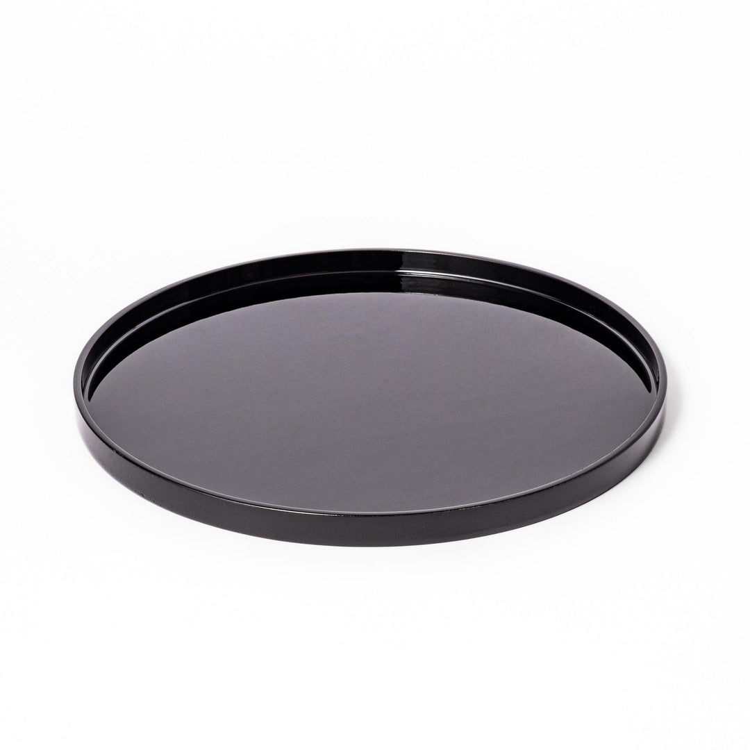 Glossy black Japanese round wooden tray with raised rim, ideal for serving tea or displaying tableware with a refined and minimalist aesthetic.