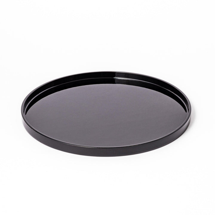 Glossy black Japanese round wooden tray with raised rim, ideal for serving tea or displaying tableware with a refined and minimalist aesthetic.