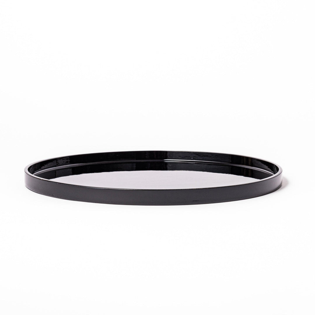 Glossy black Japanese round wooden tray with raised rim, ideal for serving tea or displaying tableware with a refined and minimalist aesthetic.