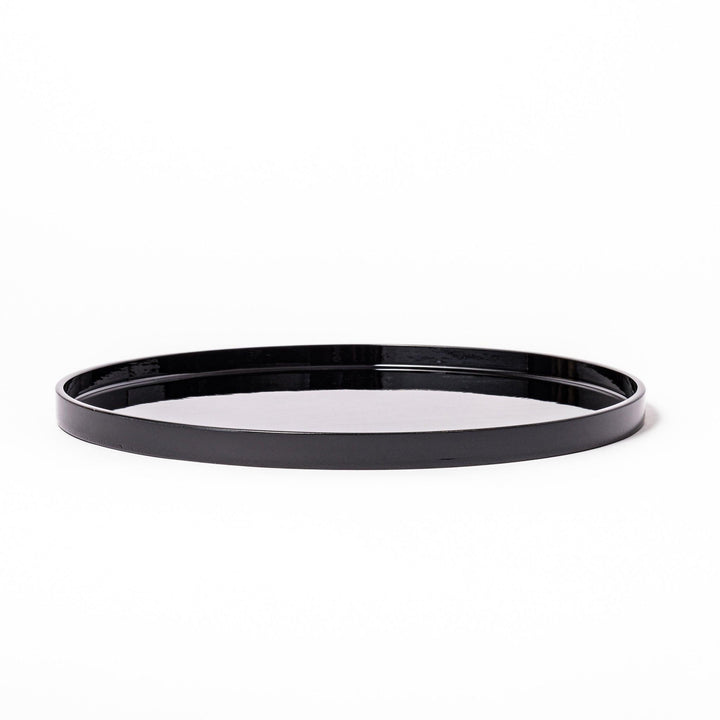Glossy black Japanese round wooden tray with raised rim, ideal for serving tea or displaying tableware with a refined and minimalist aesthetic.