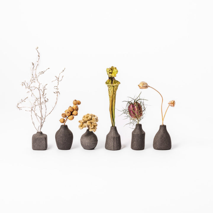 Minimalist dark ceramic bud vases with dried flowers, perfect for adding a touch of modern Japanese decor to any room or table.