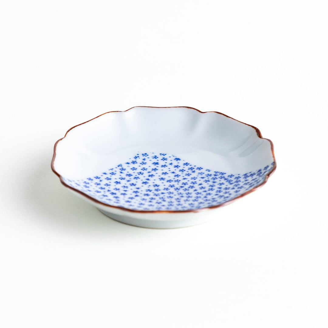 A small dish with a soft blue Mount Fuji pattern filling most of the surface, with a white section creating an abstract mountain-like shape.