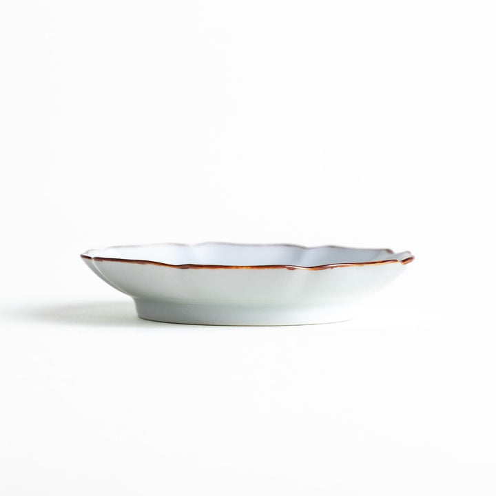 A small dish with a soft blue Mount Fuji pattern filling most of the surface, with a white section creating an abstract mountain-like shape.