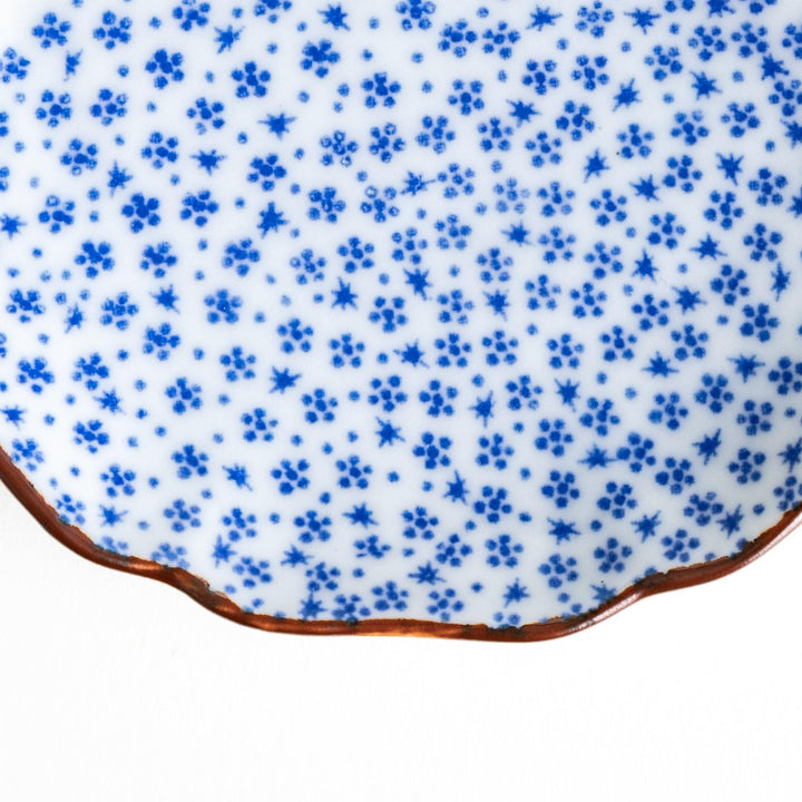 A small dish with a soft blue Mount Fuji pattern filling most of the surface, with a white section creating an abstract mountain-like shape.