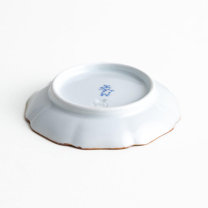 A small dish with a soft blue Mount Fuji pattern filling most of the surface, with a white section creating an abstract mountain-like shape.