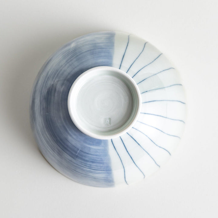 A white ceramic bowl with vertical blue stripes in a simple, clean design.