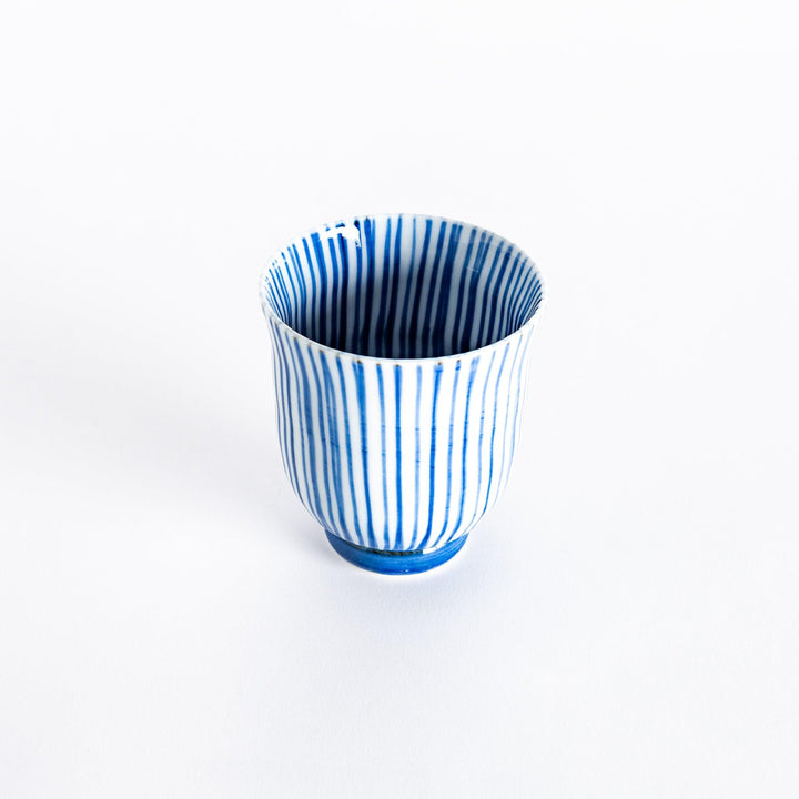 Slightly angled view of the blue-striped tea cup, highlighting its elegant shape and vertical stripe pattern.