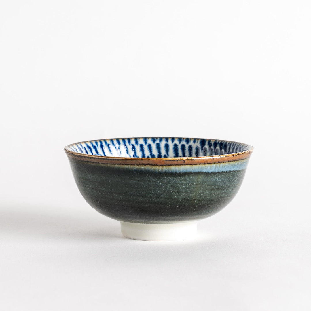 A round dessert bowl adorned with a sprial blue pattern spreading from the center.