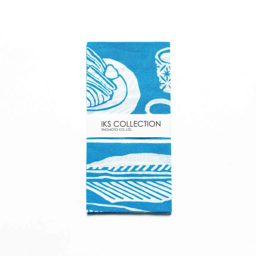 Light blue tenugui, folded with a product sleeve highlighting white fish designs.
