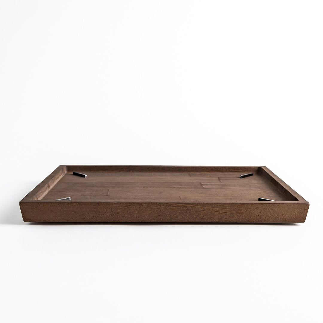 Low-profile view of a rectangular wooden board with a raised edge.