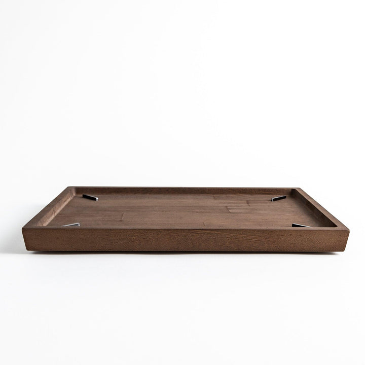Low-profile view of a rectangular wooden board with a raised edge.