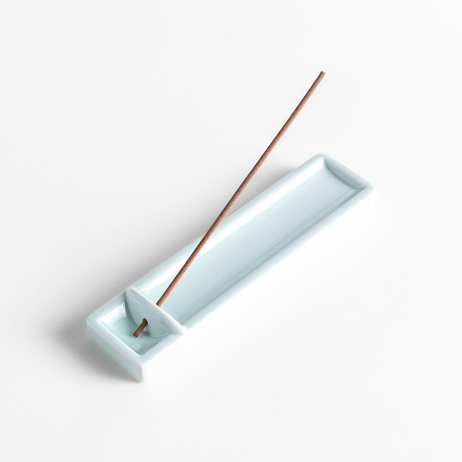 Incense Holder in a sleek celadon ceramic design with a built-in slot for holding sticks, featuring a rectangular shape that elegantly catches falling ash.