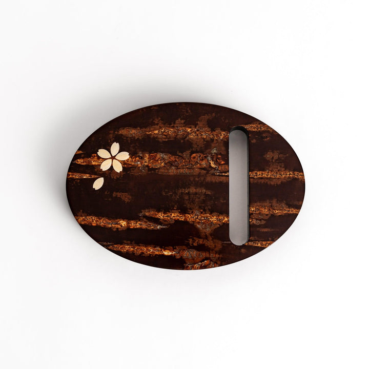 Oval-shaped cherry bark teapot rest with a beautiful natural grain and a delicate cherry blossom inlay, adding a touch of elegance to your tea time.