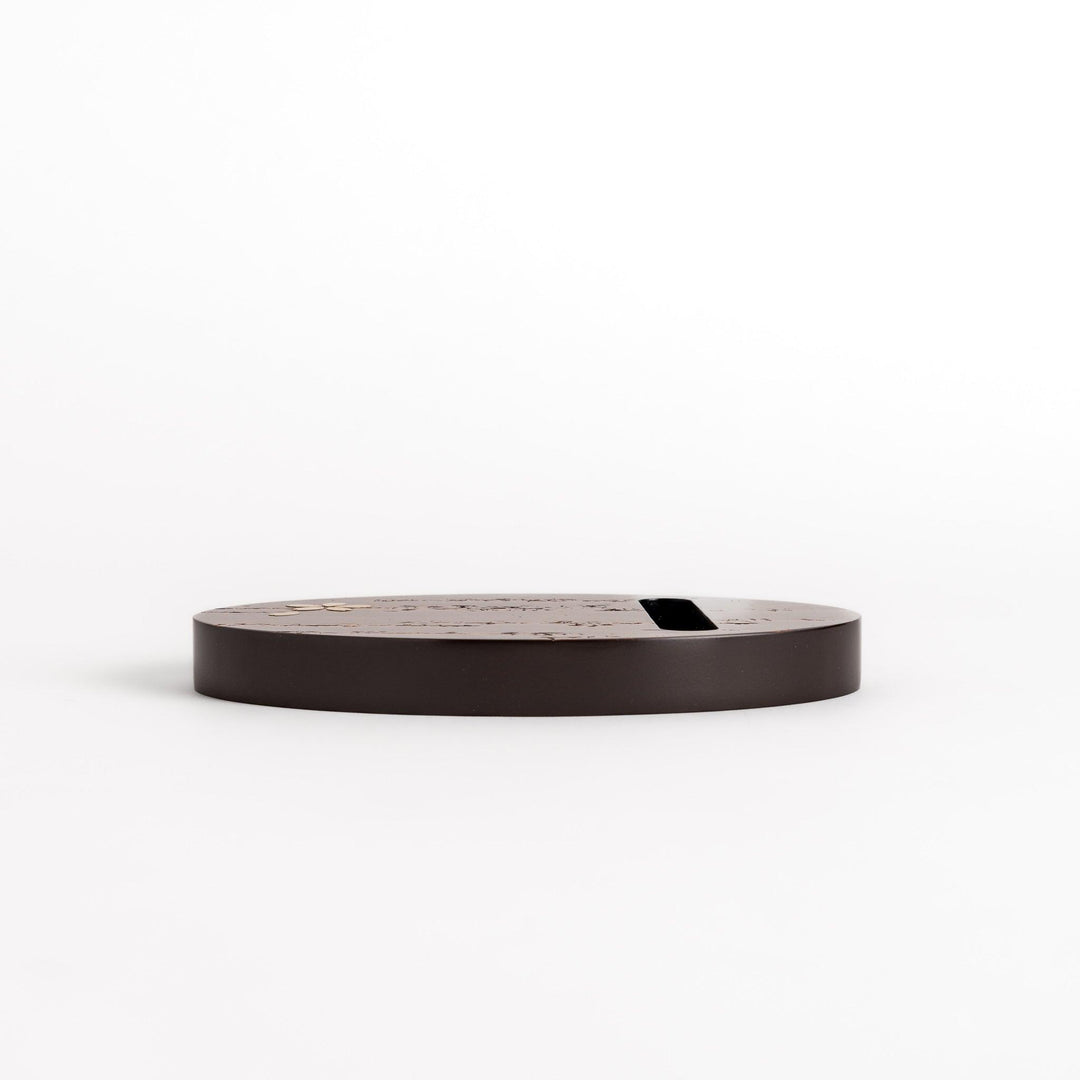 Oval-shaped cherry bark teapot rest with a beautiful natural grain and a delicate cherry blossom inlay, adding a touch of elegance to your tea time.