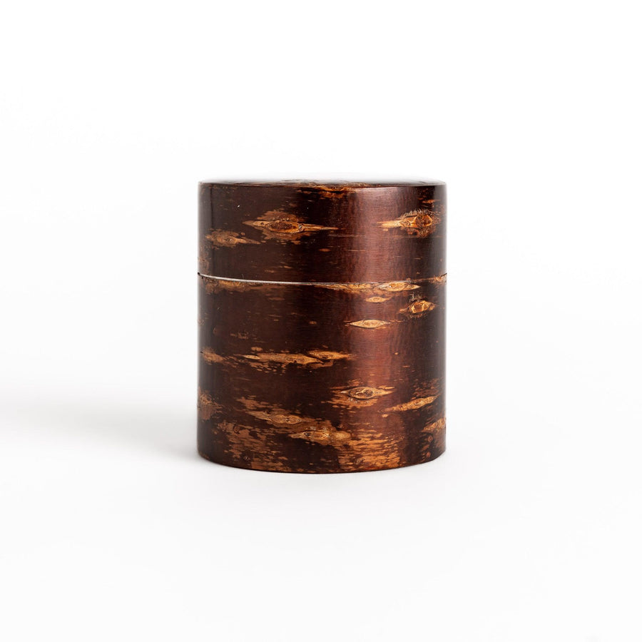 Classic cherry bark tea canister with a rich, dark brown finish and a natural wood grain, ideal for storing and preserving loose leaf tea.