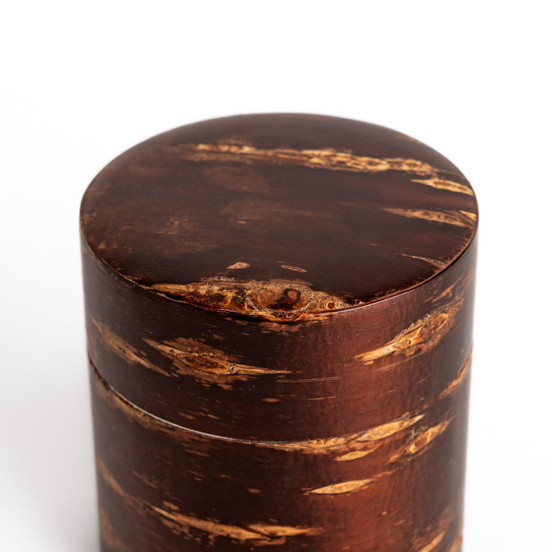 Classic cherry bark tea canister with a rich, dark brown finish and a natural wood grain, ideal for storing and preserving loose leaf tea.