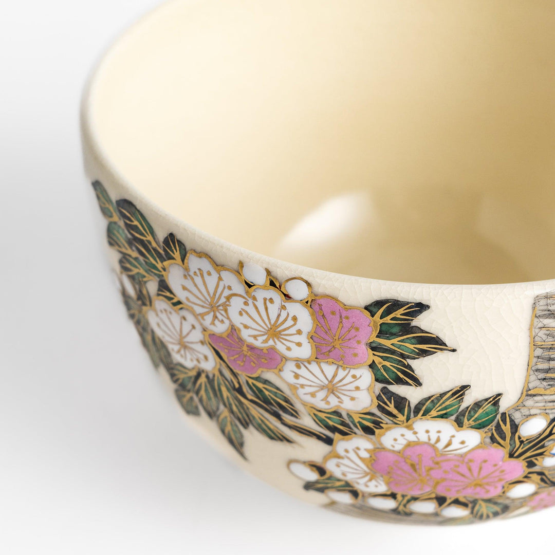 Beautiful Matcha Bowl adorned with delicate cherry blossom and tree motifs, accented with gold detailing for an elegant tea experience.