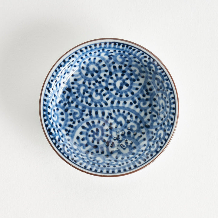 A round saucer with traditional blue floral patterns.