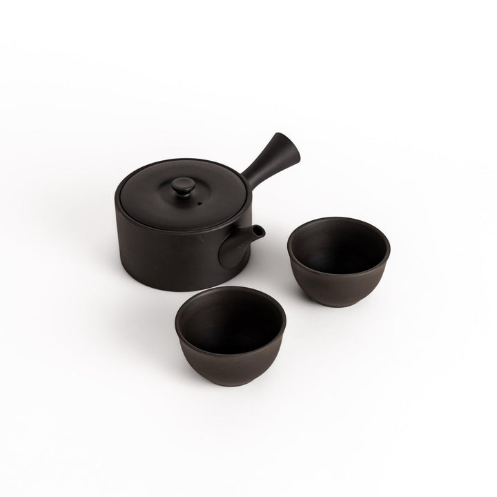 Elegant black tea set featuring a round teapot with spout and matching bowls, perfect for enjoying tea in style and simplicity.