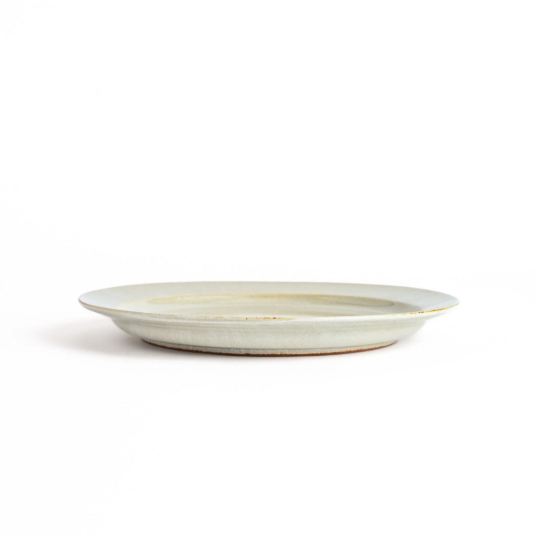 White ceramic dinner plate with a glossy finish, offering a clean and timeless design perfect for various table settings.