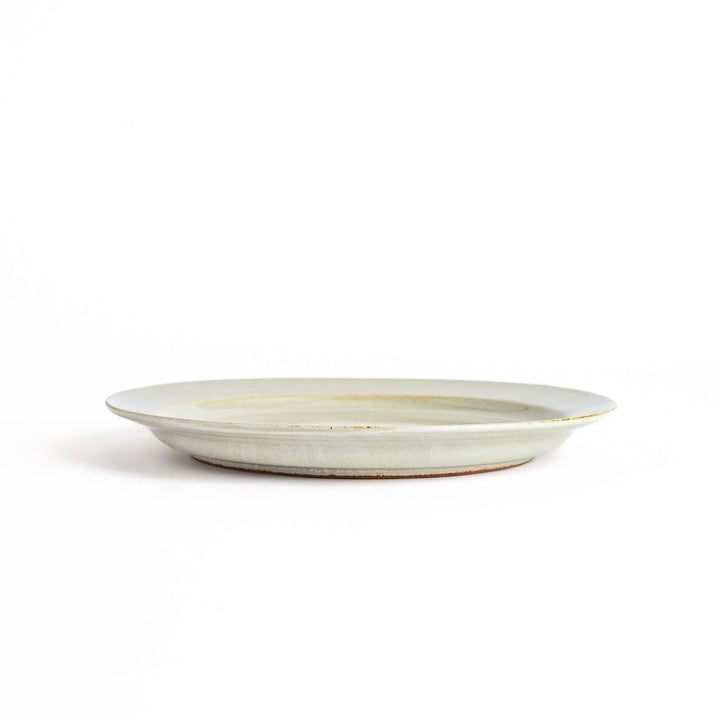 White ceramic dinner plate with a glossy finish, offering a clean and timeless design perfect for various table settings.